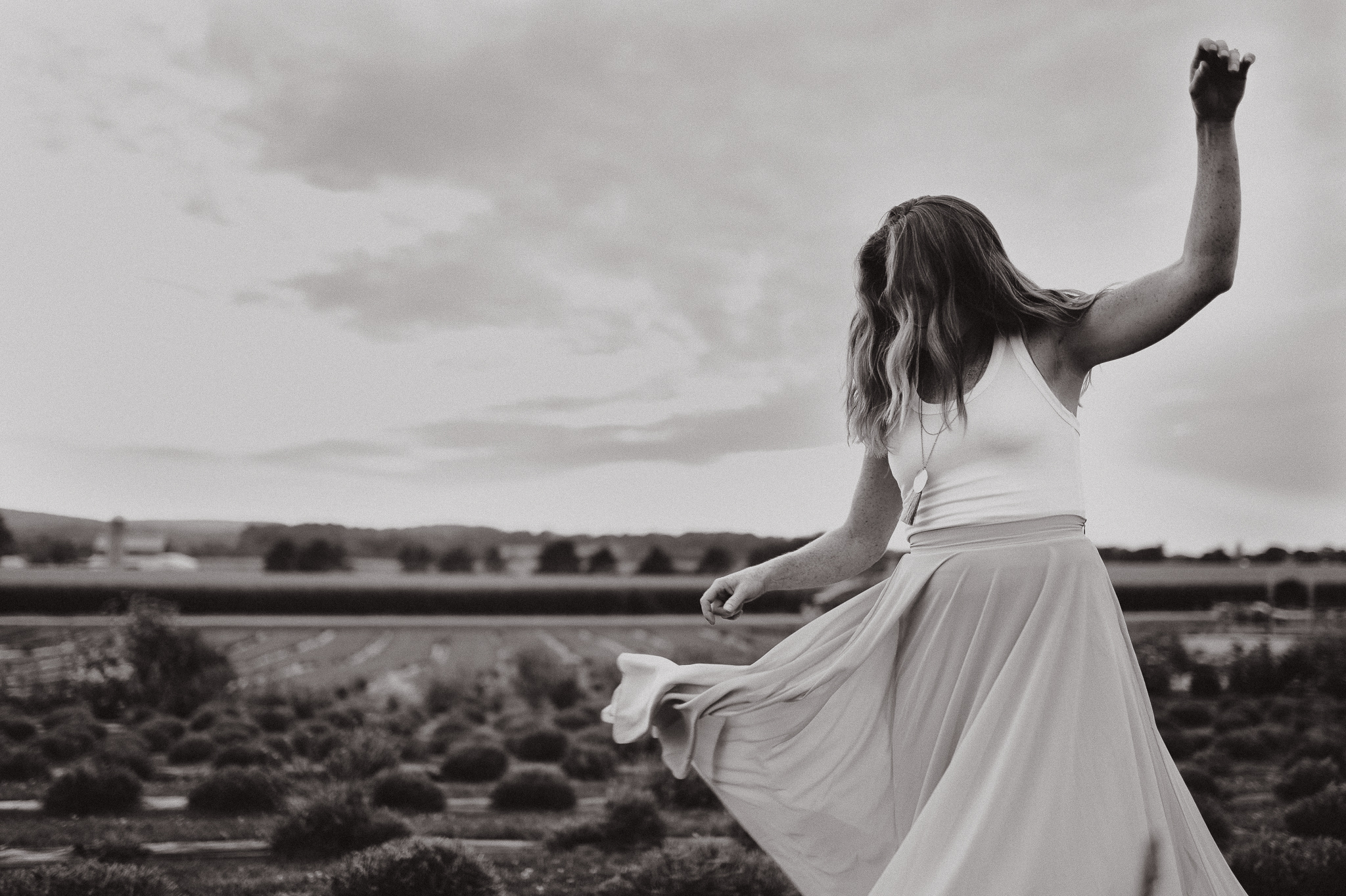 Red headed woman in yellow skirt at sunset in a lavender field.